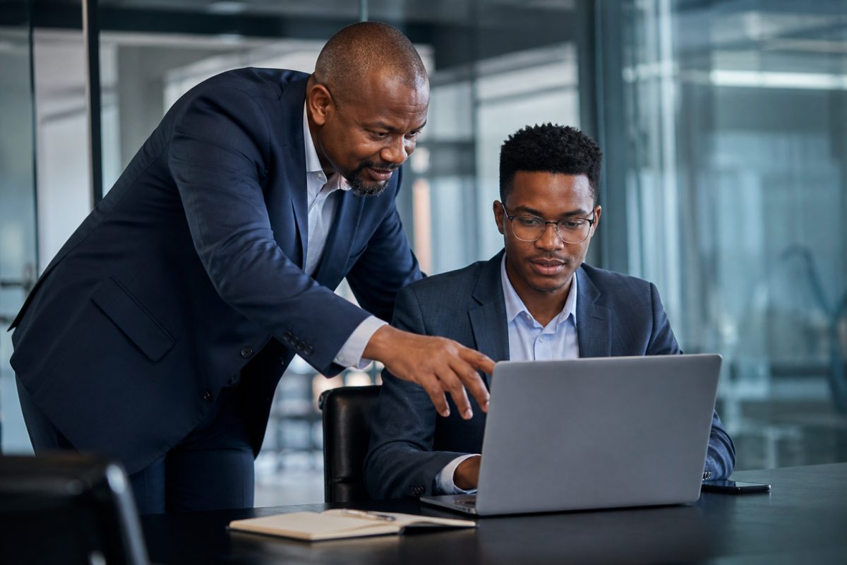 CEFA mentor coaching a graduate in a modern meeting room